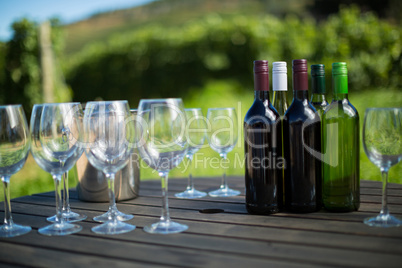 Wineglasses and bottles on table