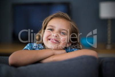 Cute girl smiling at camera in living room
