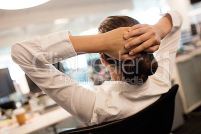 Businesswoman relaxing on chair in office