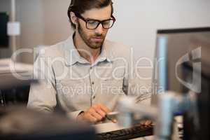 Young businessman typing on computer keyboard in office