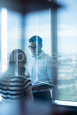 Business couple reading diary in office