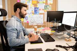 Designer using digitizer and stylus on creative office desk