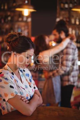 Upset woman ignoring affectionate couple