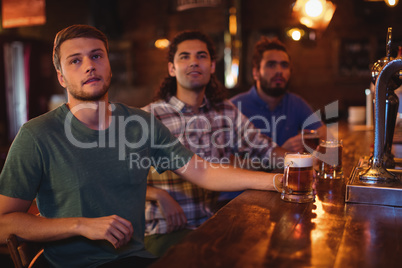 Group of male friends watching football match