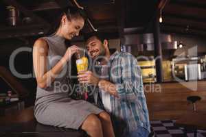 Happy couple having milkshake