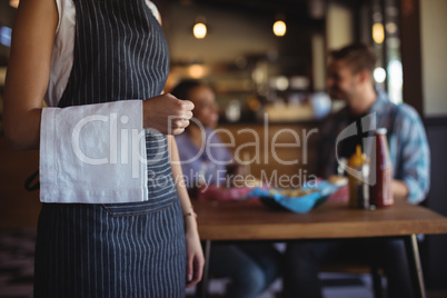 Waitress with napkin standing at restaurant