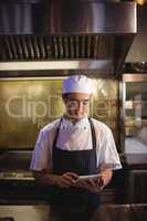 Chef using digital tablet in the commercial kitchen