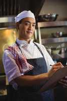 Chef writing on a clipboard