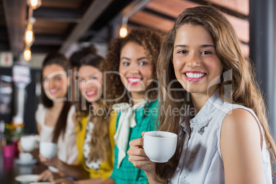 Female friends having coffee in cafe