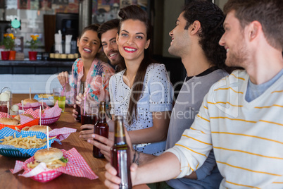 Happy friends having lunch in restaurant