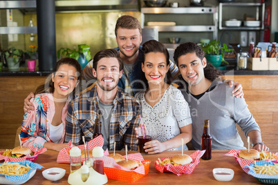Smiling friends enjoying in restaurant