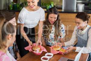 Waitress serving customers in restaurant