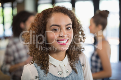 Smiling young woman standing in restaurant