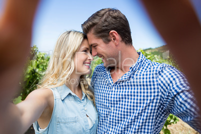 Smiling young couple at vineyard