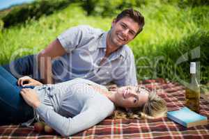 Portrait of happy young couple enjoying on blanket