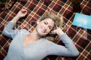 Portrait of woman lying on blanket