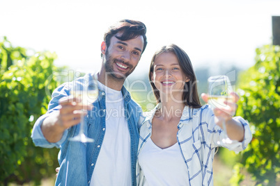 Portrait of smiling couple showing wineglasses