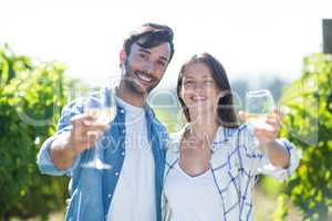 Portrait of smiling couple showing wineglasses