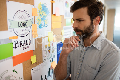 Thoughtful businessman looking at chart