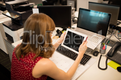 Businesswoman using digital tablet in office