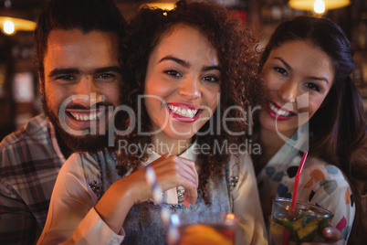 Portrait of young friends having drinks