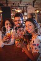 Portrait of young friends having drinks