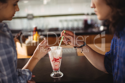 Couple having milkshake at counter