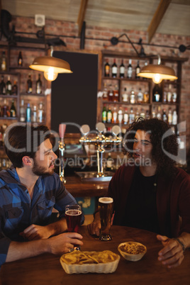 Friends having beer in pub