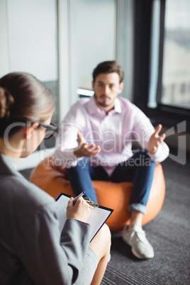 Unhappy man consulting counselor