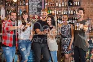 Happy friends holding drinks