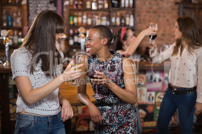 Happy females holding wineglasses