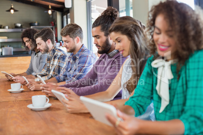 Friends using digital tablets in restaurants