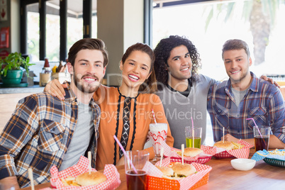 Cheerful friends sitting in restaurant