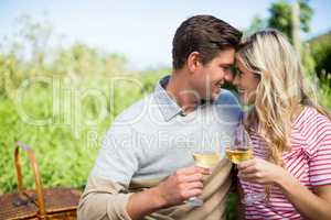 Smiling couple face to face holding wineglasses