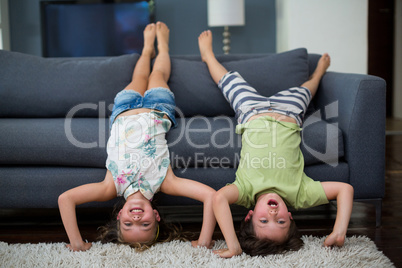 Siblings having fun in living room