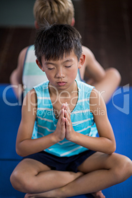 Boy performing yoga at home