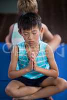 Boy performing yoga at home
