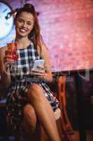 Portrait of two young women having cocktail drinks