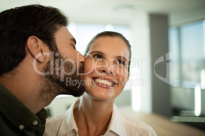 Close up of businessman kissing businesswoman
