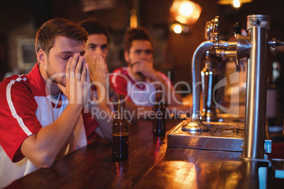 Group of male friends watching football match