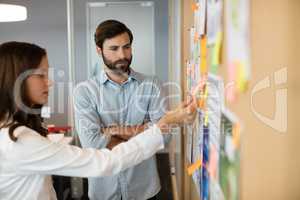 Serious business colleagues analyzing charts in office