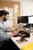 Designer working with digital tablet and laptop in creative office