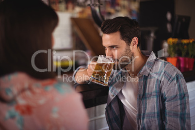 Couple having beer at counter