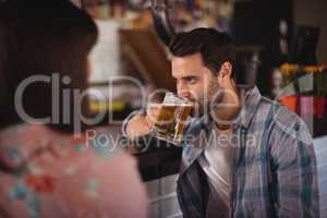 Couple having beer at counter