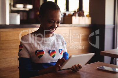 Happy woman using digital tablet