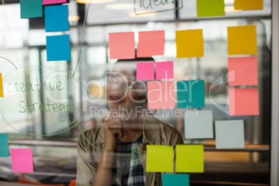Female executive looking at sticky notes