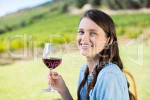 Portrait of smiling woman holding red wine