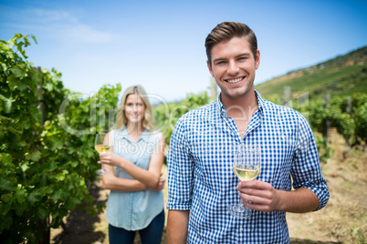 Smiling young man holding wineglass