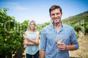 Smiling young man holding wineglass