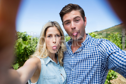 Portrait of happy young couple at vineyard